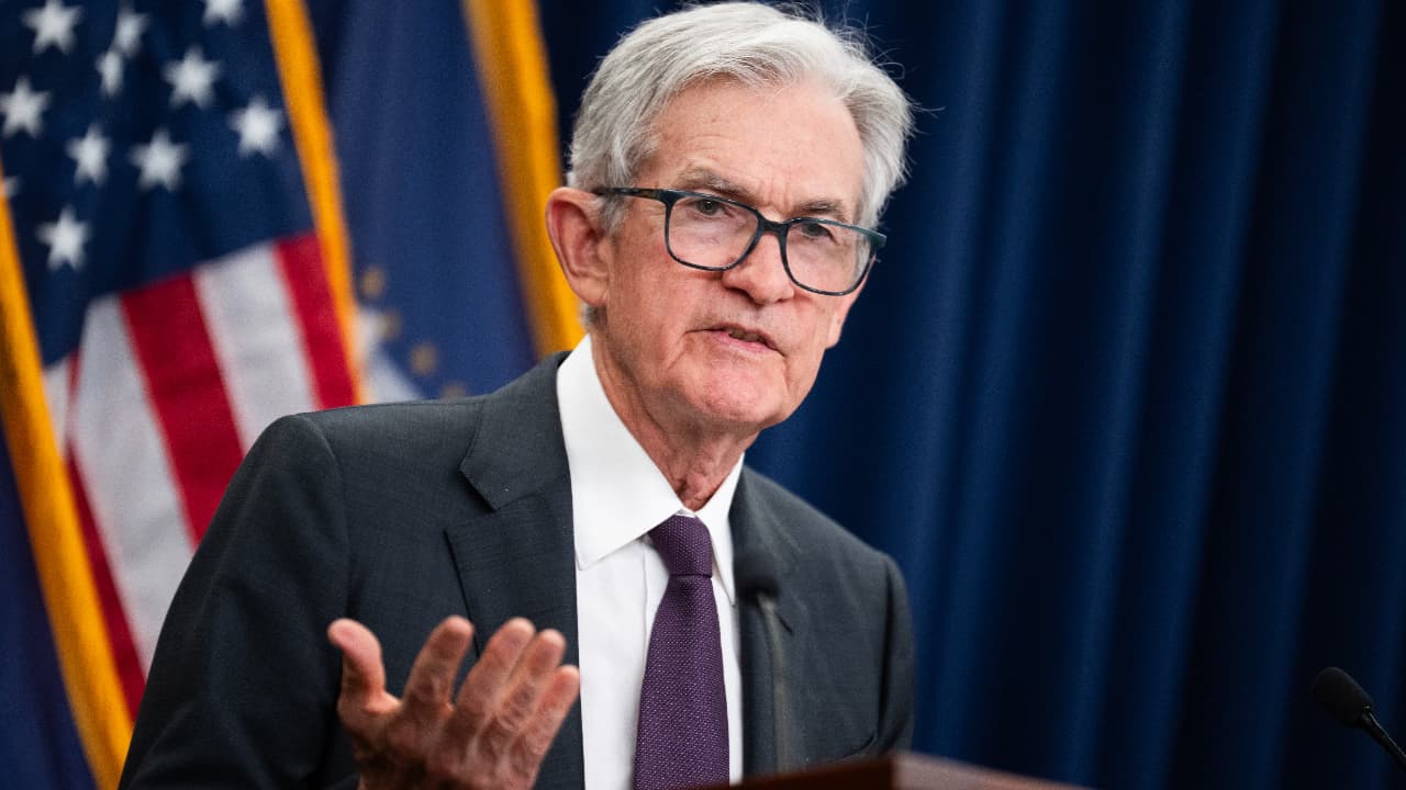 U.S. Federal Reserve Chairman delivering remarks after announcing an interest rate cut and the end of quantitative tightening.
